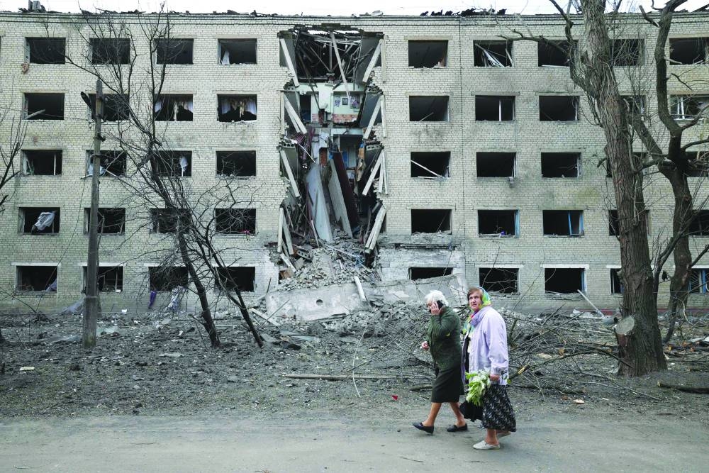 
Elderly women walk past a hostel destroyed during a missile attack in the town of Selydove, in Ukraine’s Donetsk region. 