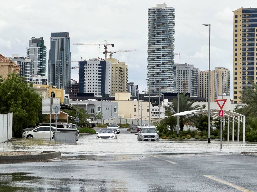 Cars drive through a flooded street in Dubai on Tuesday. REUTERS