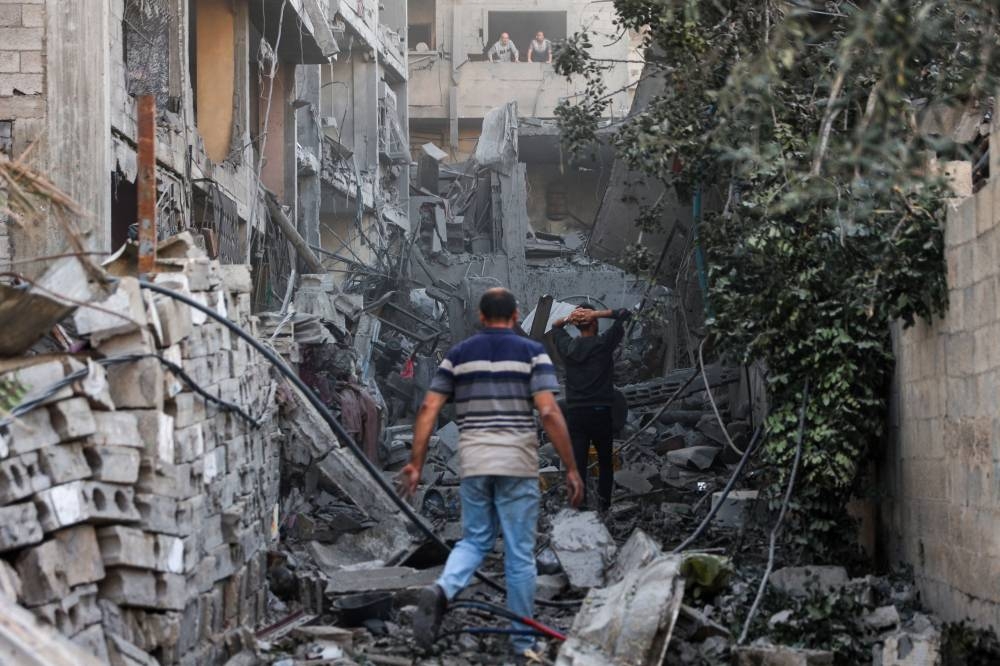 Palestinians check the rubble of a building after Israeli bombardment at Al-Daraj neighbourhood in Gaza City Tuesday.