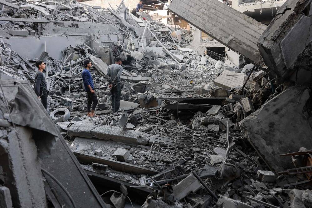 Palestinians check the rubble of a building after Israeli bombardment at Al-Daraj neighbourhood in Gaza City Tuesday.