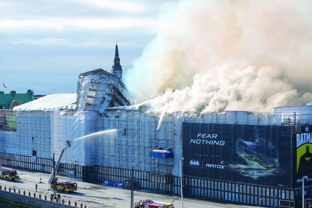 
Plumes of smoke billow from the historic Borsen stock exchange building in central Copenhagen. 
