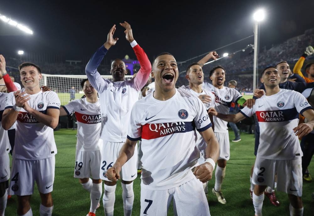 Paris St Germain's Kylian Mbappe with teammates celebrate after the match. REUTERS