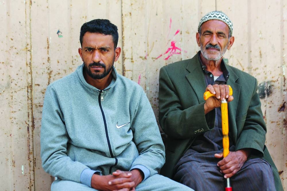 
Mahmoud Oroq (left), the father of Palestinian boy Zein, who was wounded after he was hit by aid airdropped on Gaza and later succumbed to his wounds, looks on as he sits next to his father near their house which was hit in an Israeli strike, amid the ongoing conflict, in Gaza City. 