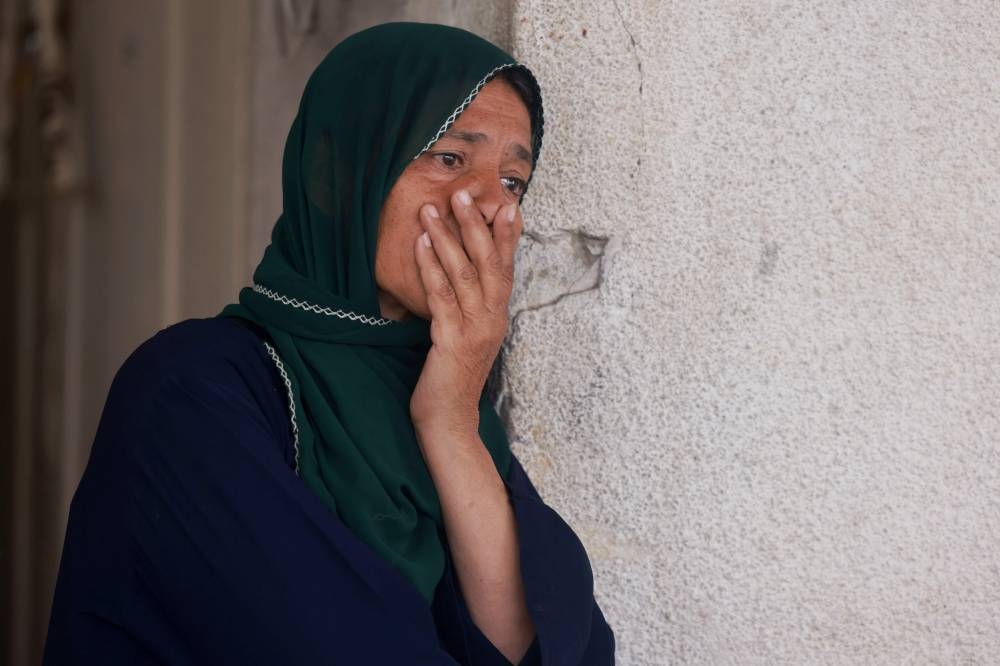 A Palestinian woman mourns the death of a loved one at Al-Najjar hospital following overnight Israeli bombardment in Rafah in the southern Gaza Strip, on Thursday. AFP