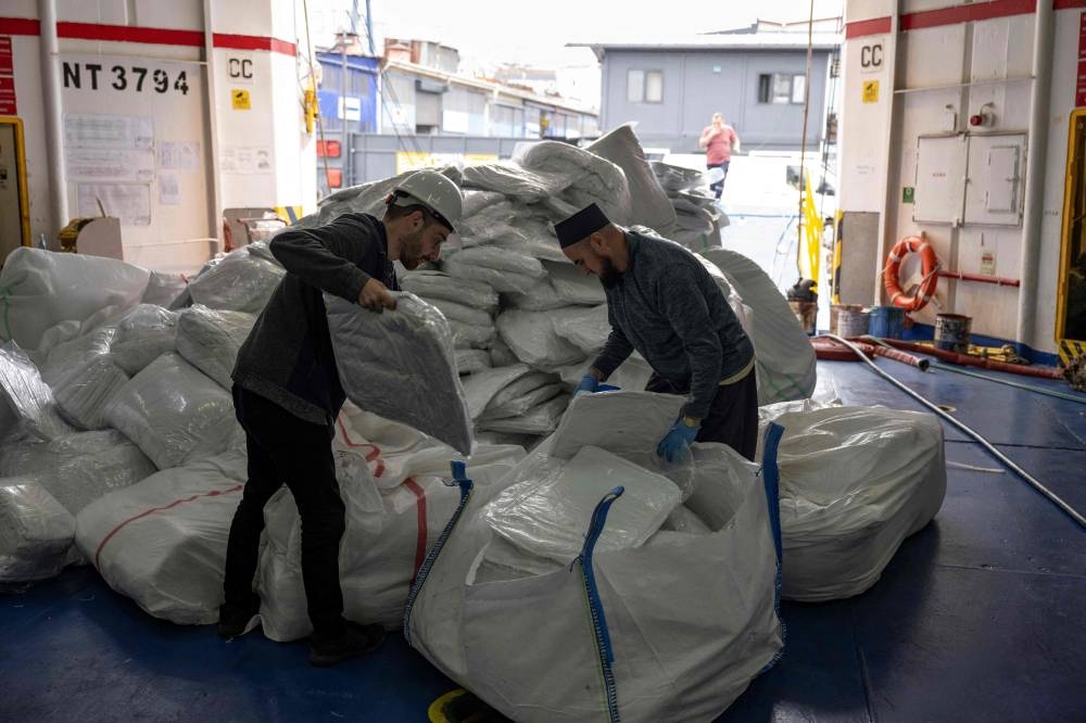 Workers prepare a ship from the Freedom Flotilla Coalition while it anchors in the Tuzla seaport, near Istanbul on Friday. AFP