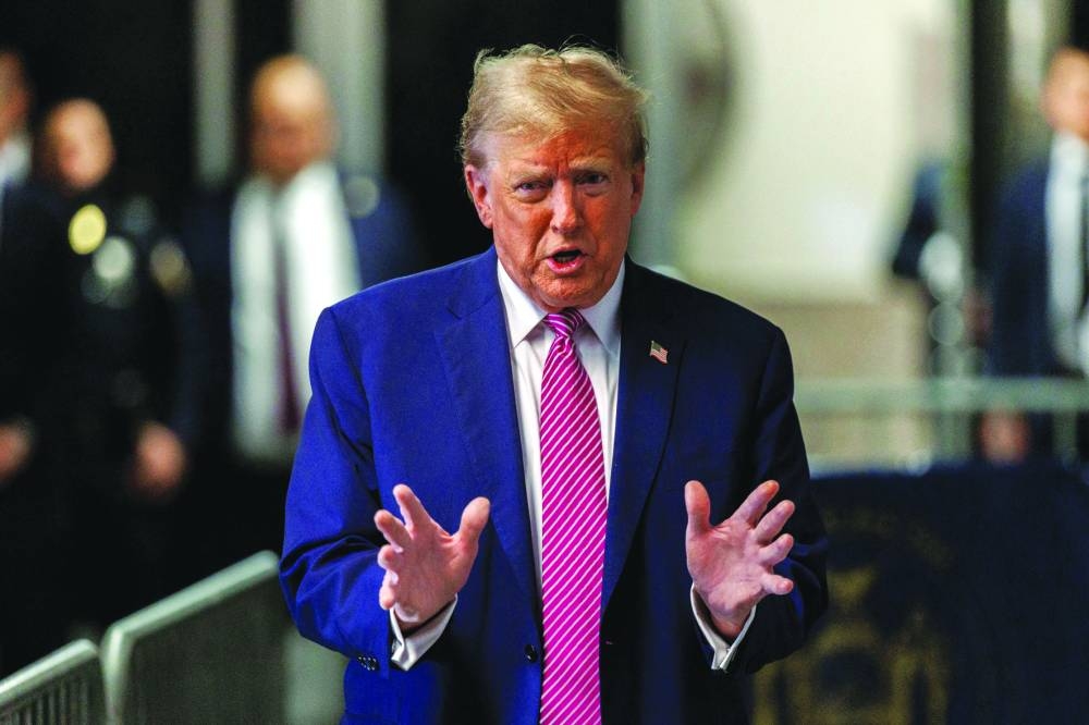 
Left: Trump speaks to the press before his trial at Manhattan Criminal Court in New York. 