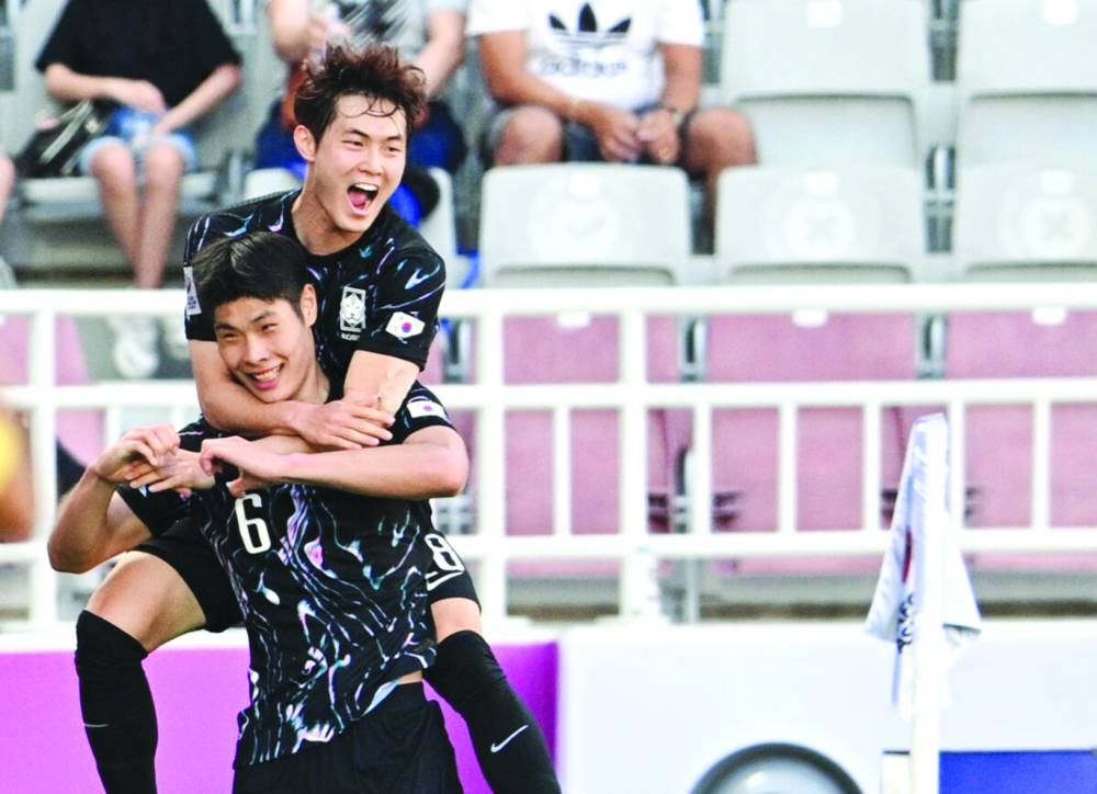 Lee Young-jun (front) netted both the goals in South Korea’s win over China at the Abdullah Bin Khalifa Stadium.