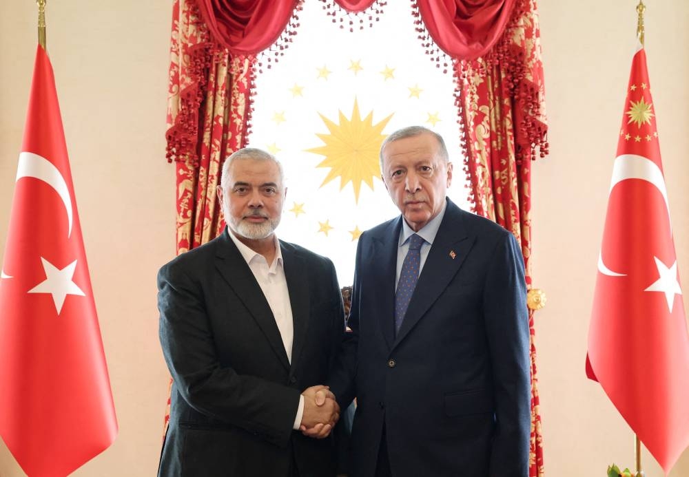 Turkey's President Tayyip Erdogan meets with Ismail Haniyeh, leader of Hamas, in Istanbul, Turkey, on Saturday. Murat Cetinmuhurdar/Turkish Presidential Press Office/Handout via REUTERS