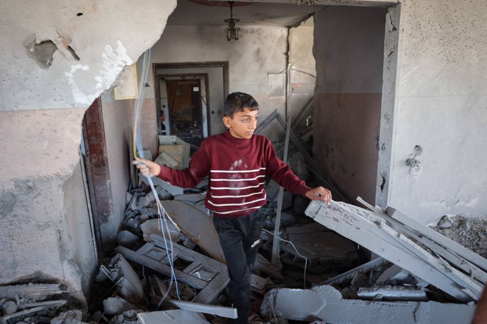 A Palestinian child checks the rubble of a house hit by overnight Israeli bombing in Rafah in the southern Gaza Strip on Saturday. AFP