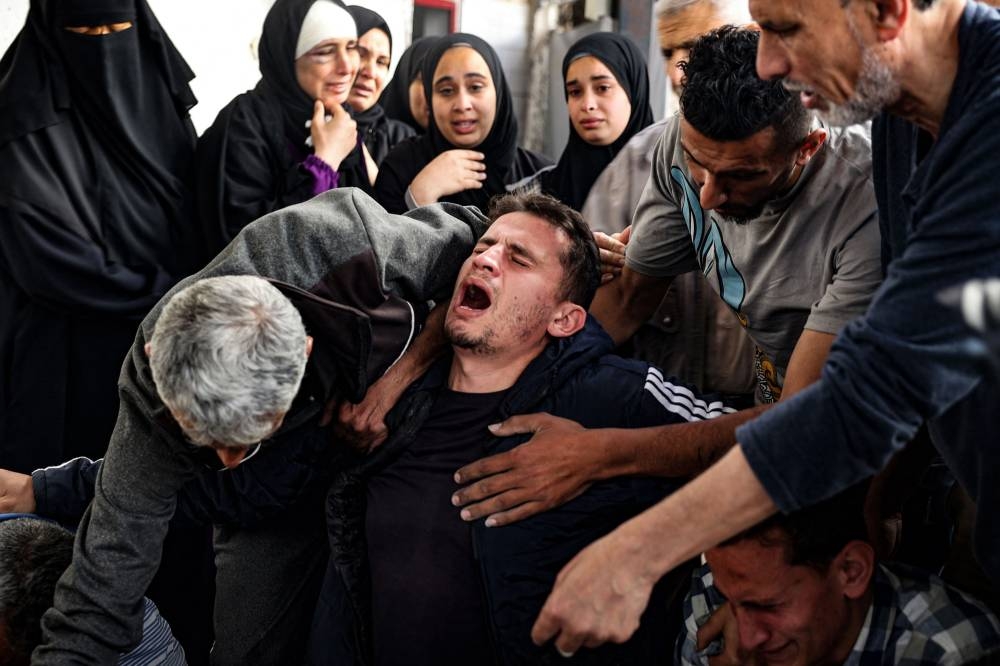 A Palestinian man mourns relatives killed in Israeli bombing in Rafah in the southern Gaza Strip on Saturday. AFP