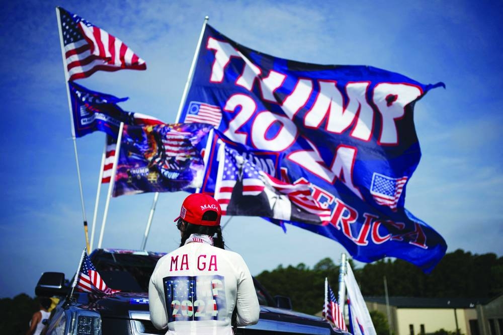 
A supporter of the Republican presidential candidate waits in a parking lot ahead of a campaign rally in Wilmington, North Carolina, yesterday.  (Reuters) 