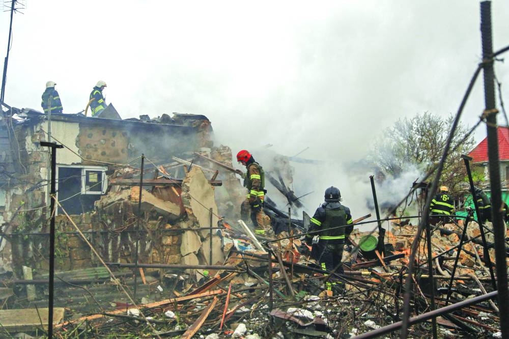 
Firefighters work at the site in Odesa where residential buildings were 
damaged by a Russian missile strike, amid Russia’s attack on Ukraine. 