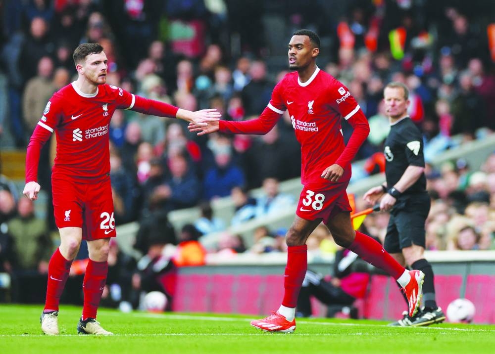 Liverpool’s Ryan Gravenberch (right) celebrates with Andrew Robertson after scoring a goal during their Premier League match against Fulham in London yesterday. (Reuters)