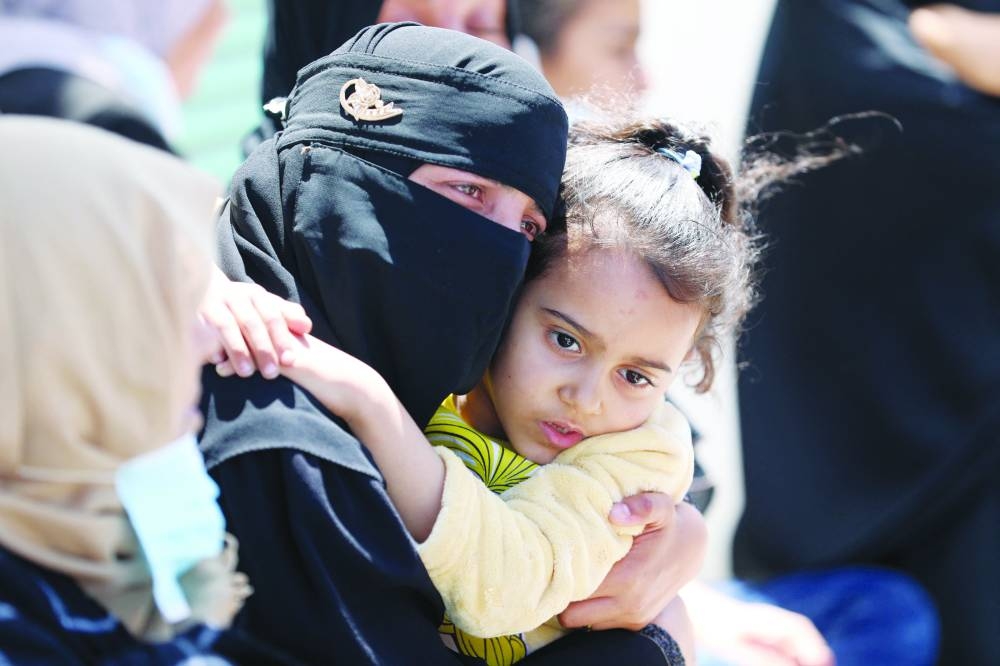 Mourners are seen as people rebury the bodies of Palestinians killed during Israel's military offensive and buried earlier at Nasser hospital, in Khan Younis in the southern Gaza Strip.