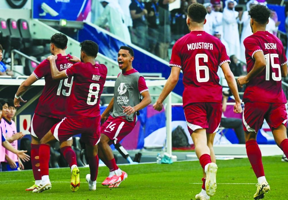 Qatar’s Ahmed al-Rawi (left) celebrates with teammates after scoring against Japan in their AFC U-23 Asian Cup Qatar 2024 quarter-final at Jassim Bin Hamad Stadium in Doha on Thursday.