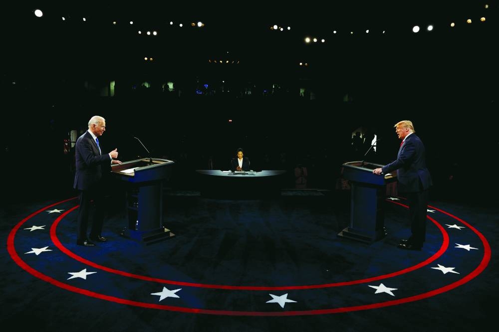 This picture taken on October 22, 2020 shows then Democratic presidential nominee Joe Biden and then-President Donald Trump at their second 2020 presidential campaign debate at Belmont University in Nashville.