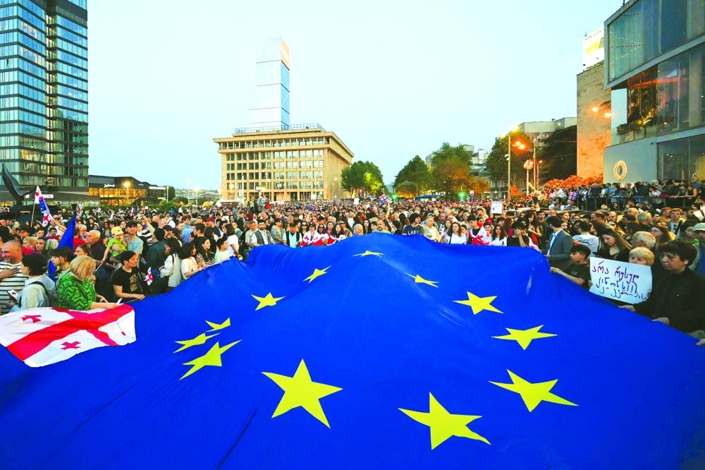 
Demonstrators hold a giant EU flag during their protest against a controversial ‘foreign influence’ bill, which Brussels warns would undermine Georgia’s European aspirations, in Tbilisi. 