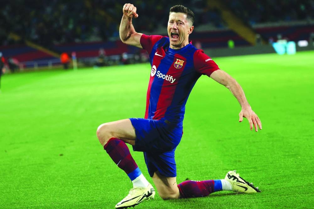 
Barcelona’s Robert Lewandowski celebrates after scoring against Valencia on Monday. (AFP) 