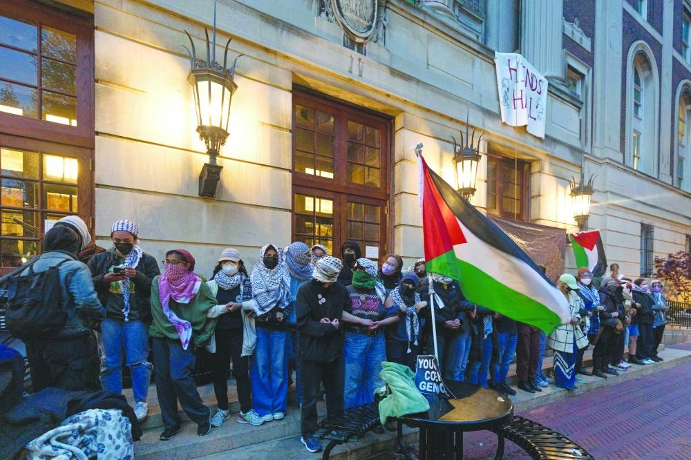 Pro-Palestinian student protesters lock arms at the entrance to Hamilton Hall on the campus of Columbia University, in New York City. 