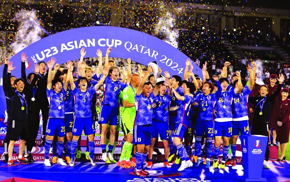 Japan players celebrate with the trophy after winning the AFC U-23 Asian Cup at the Jassim Bin Hamad Stadium in Doha on Friday. PICTURES: Noushad Thekkayil