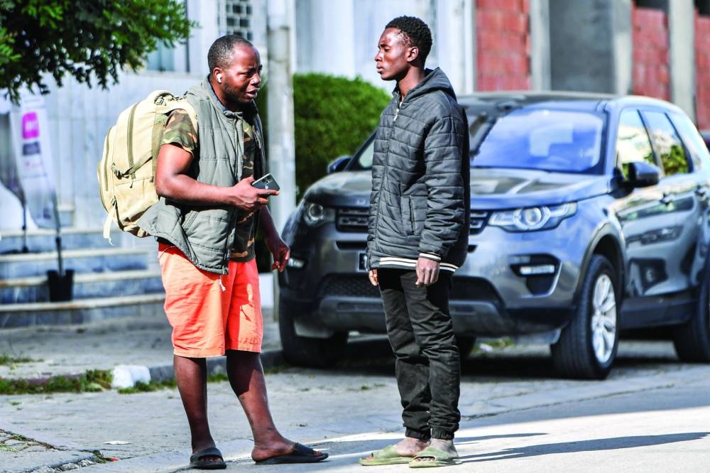 Sudanese men stand outside the International Organisation for Migration (IOM) headquarters in Tunis, on Friday, after their tents there were demolished the previous night in a forced evacuation carried out by the authorities.