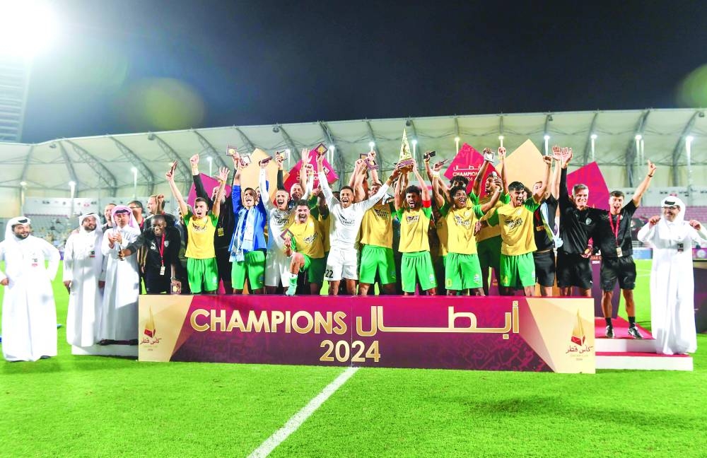 Al Wakrah players and officials celebrate with the trophy after winning the Qatar Cup at the Abdullah Bin Khalifa Stadium on Saturday.