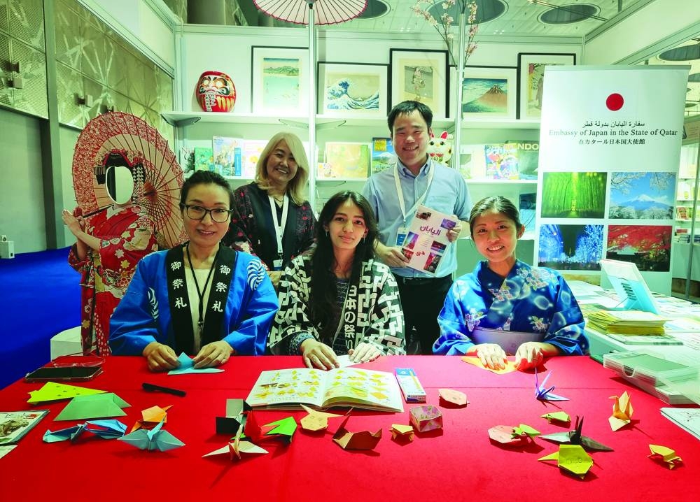 Kazuto Matsuda (right, standing) with volunteers at the Japan booth at the Doha International Book Fair on Thursday. PICTURES: Joey Aguilar