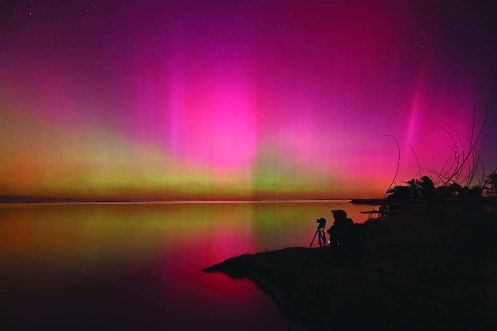 
The Aurora Australis glows over waters of Lake Ellesmere near Christchurch. 