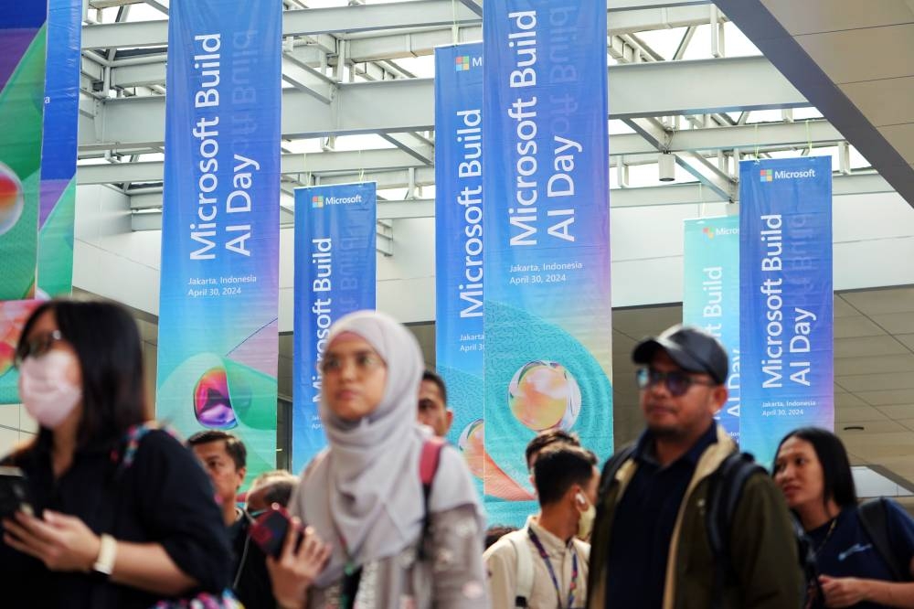 Attendees arrive for Microsoft's event on AI technologies in Jakarta on April 30, 2024. Microsoft will invest $1.7bn to build out cloud computing and artificial intelligence infrastructure in Indonesia, betting on Southeast Asia’s biggest economy to spur growth.
