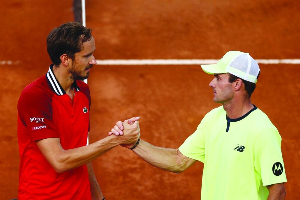 Tommy Paul of the US shakes hands with Russia's Daniil Medvedev after winning their round of 16 match at the Italian Open in Rome on Tuesday. (Reuters)