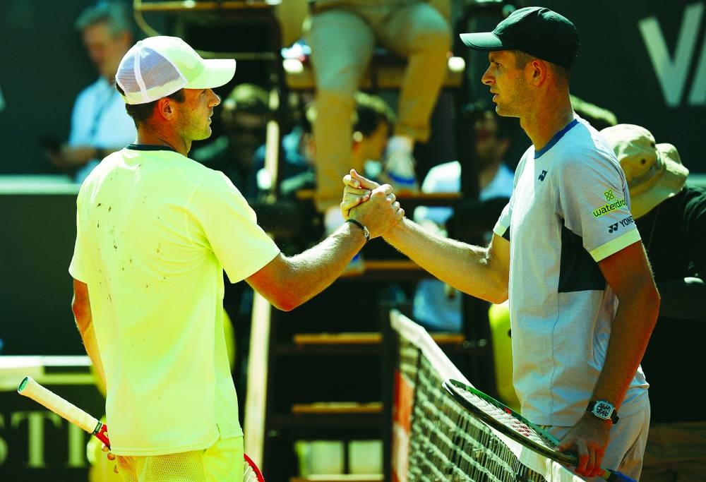 Tommy Paul (left) of the US shakes hands with Poland’s Hubert Hurkacz after winning his Rome Open quarter-final on Thursday. (Reuters)