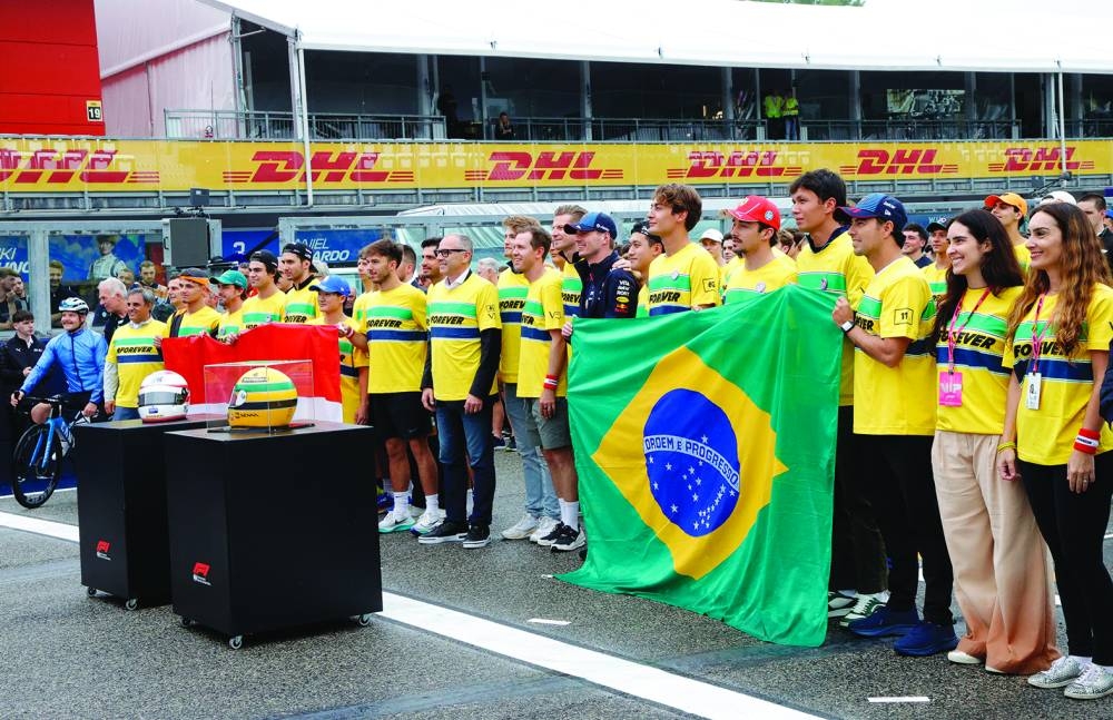 Red Bull’s Sergio Perez, Mercedes’ George Russell, Williams’ Alexander Albon, Sauber’s Guanyu Zhou and Red Bull’s Max Verstappen display Brazil and Austria flags as part of tributes to Ayrton Senna and Roland Ratzenberger following their deaths over 30 years ago. (Reuters)