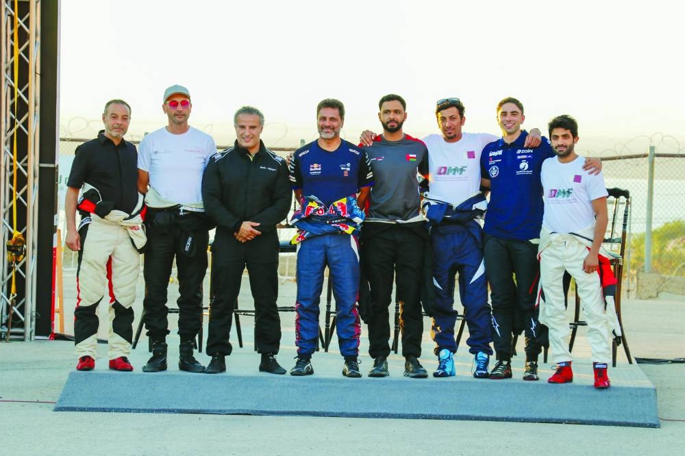 Qatari driver Nasser Saleh al-Attiyah poses with other drivers prior to the ceremonial start ceremony of the Jordan Rally on Thursday.