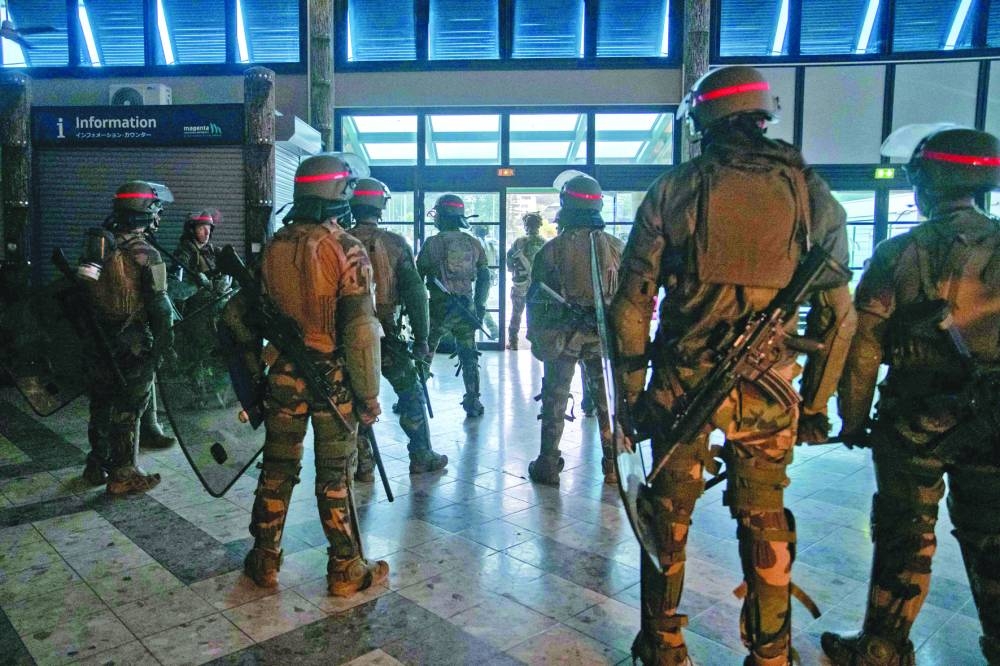 
French soldiers of the 8th Marine Infantry Regiment (8e RIMa) secure the Magenta airport in Noumea. 