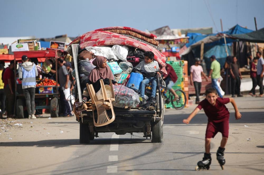 A displaced Palestinian family arrives at a temporary camp in Rafah on Friday. AFP