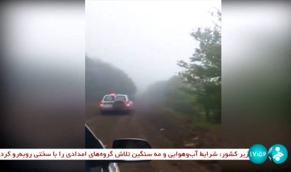 This grab taken from handout video footage released by the IRINN Iranian state television network on May 19, 2024 shows rescuers heading towards the site of the "accident" involving a helicopter in the convoy of Iran's President in the Jofa region of the western province of East Azerbaijan. 