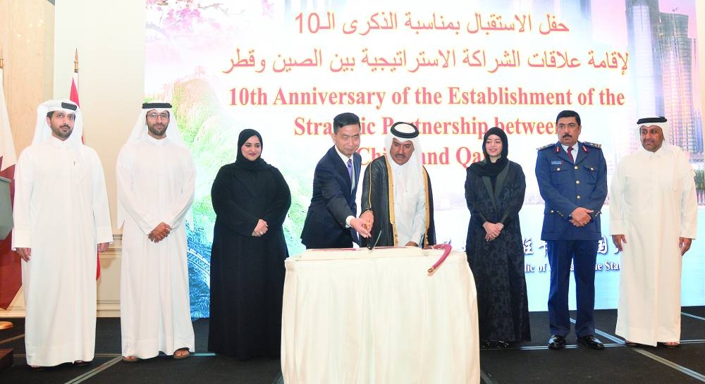 Chinese ambassador Cao Xiaolin is joined by Qatar's Ministry of Foreign Affairs Secretary-General HE Dr Ahmed bin Hassan al-Hammadi in cutting a cake on the occasion. PICTURES: Shaji Kayamkulam.