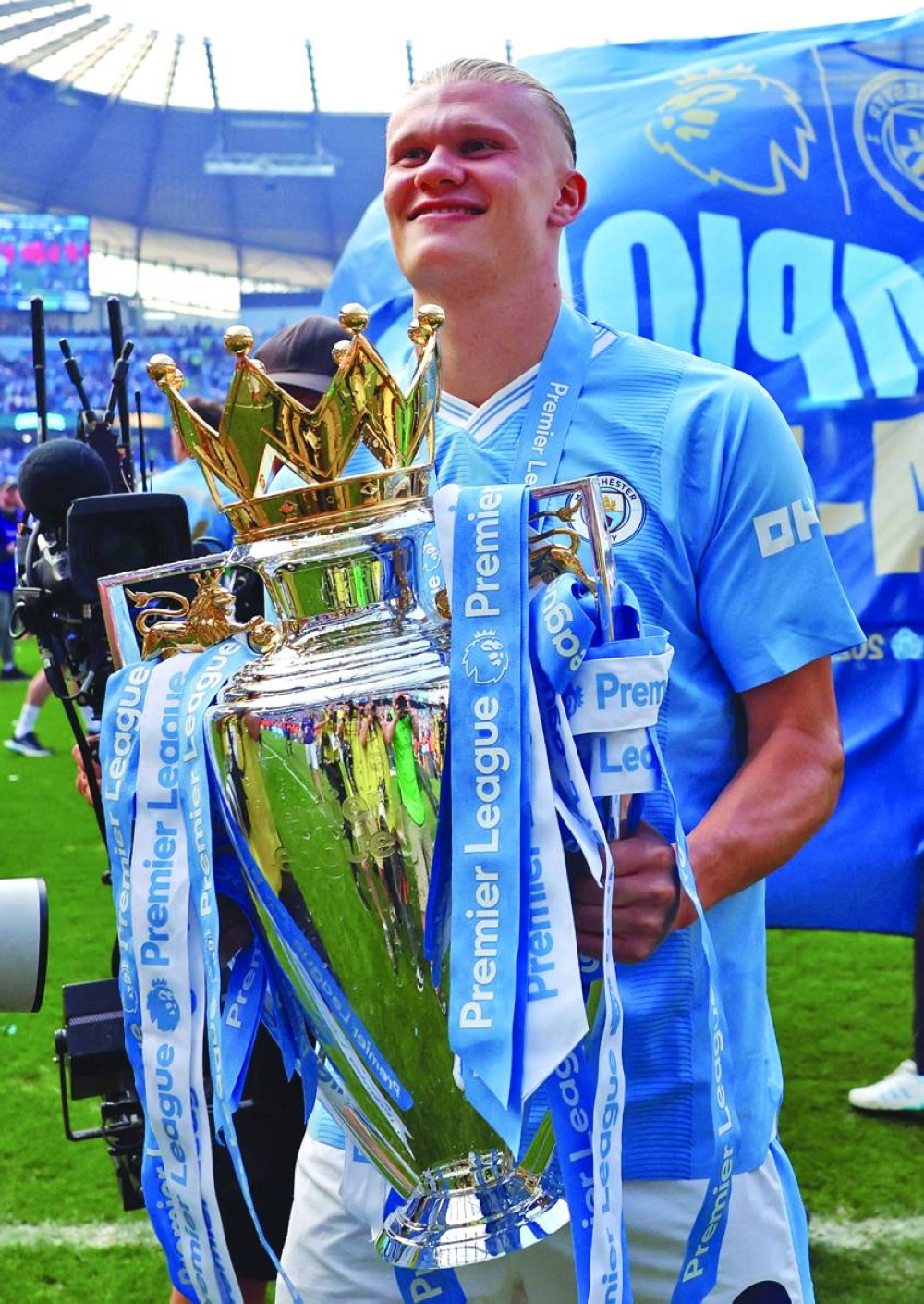 Manchester City's Erling Braut Haaland celebrates with the trophy after winning the Premier League in Manchester on Sunday. (Reuters)