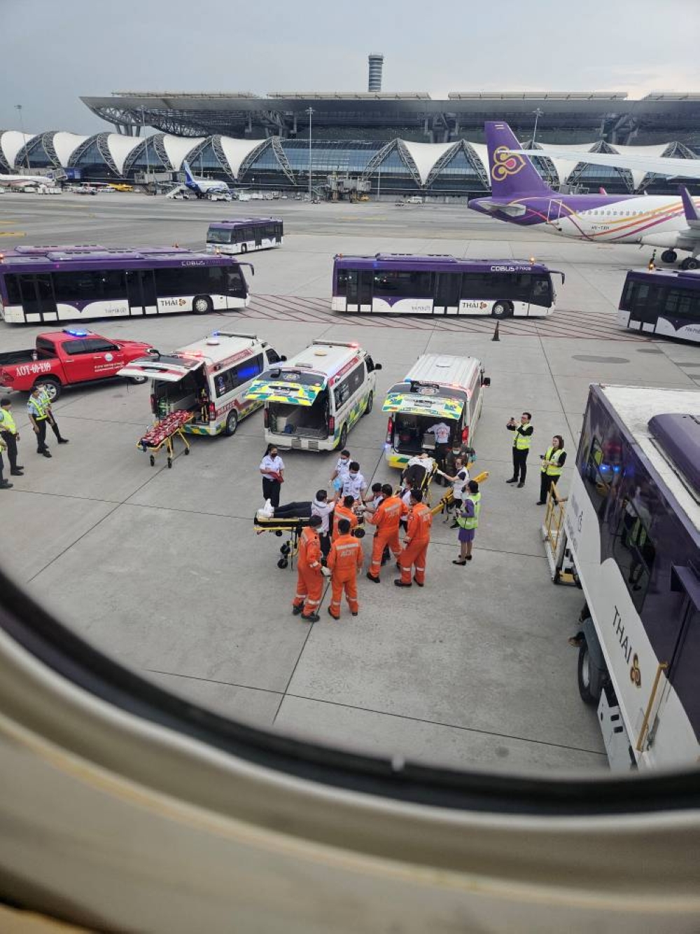 Staff member carry people on stretchers after an emergency landing at Bangkok's Suvarnabhumi International Airport, in Bangkok, Thailand on Tuesday.  Obtained by Reuters/Handout via REUTERS