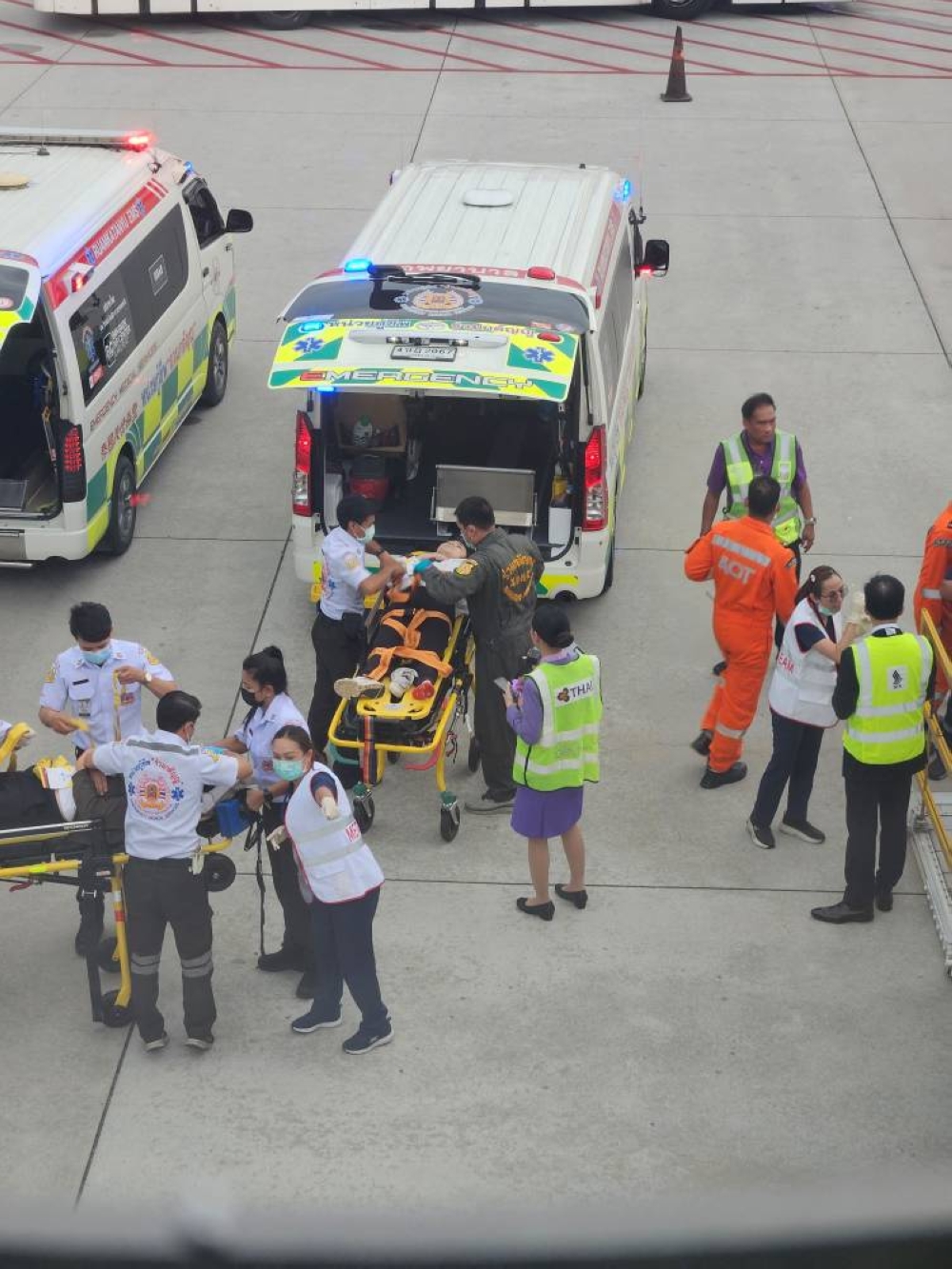 Staff member carry a person on a stretcher after an emergency landing at Bangkok's Suvarnabhumi International Airport, in Bangkok, Thailand on Tuesday.  Obtained by Reuters/Handout via REUTERS