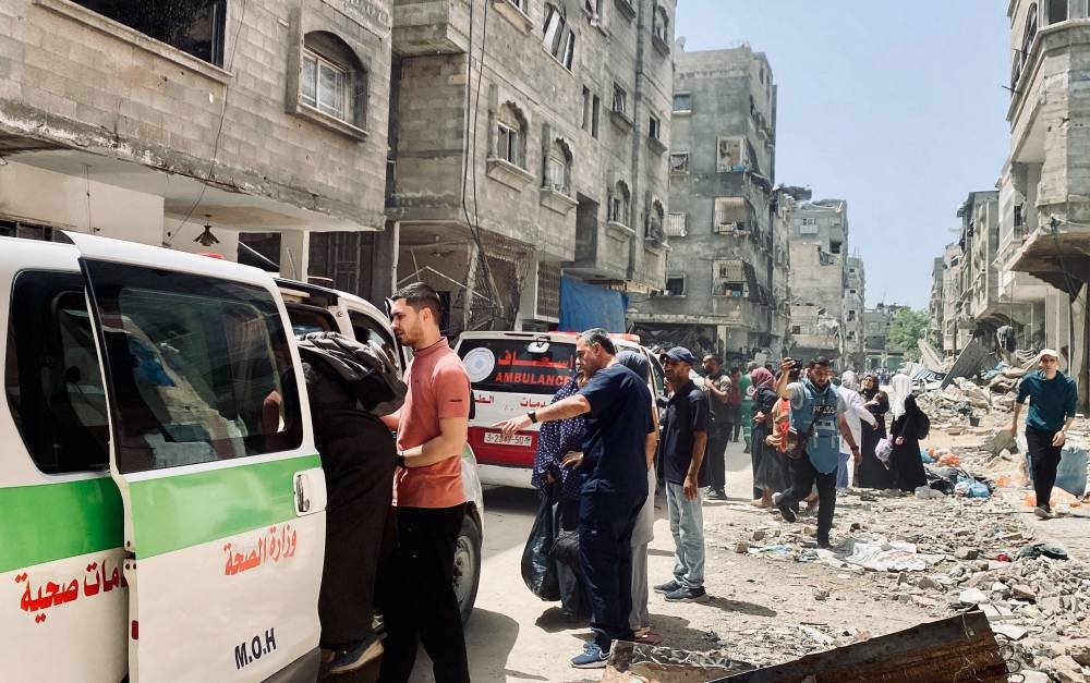 Palestinians evacuate Kamal Adwan hospital following an Israeli strike in Beit Lahia in the northern Gaza Strip, on Tuesday. REUTERS