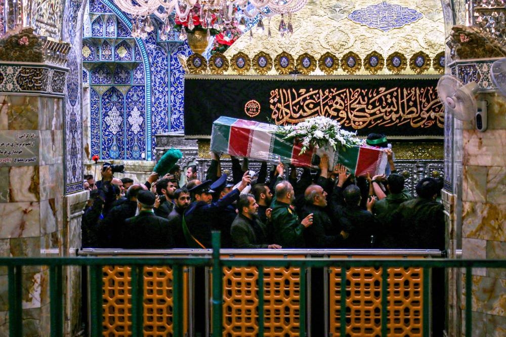 Mourners attend the funeral procession of Iran's President Ebrahim Raisi at a Muslim Shiite Shrine in Qom, on Tuesday.