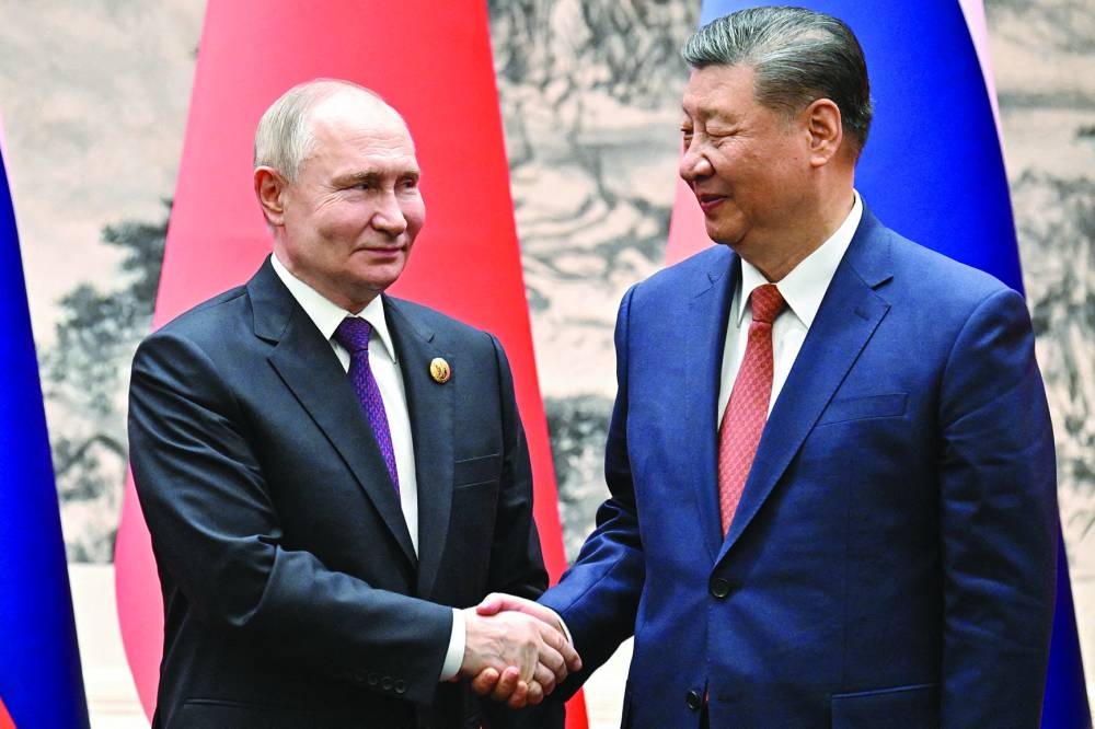 
Russian President Vladimir Putin shakes hands with Chinese President Xi Jinping during a meeting in Beijing last week. (Reuters) 