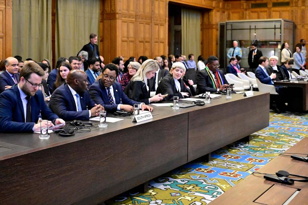 Members of the South Africa's legal team (L) attend a hearing at the International Court of Justice (ICJ) as part of South Africa's request on a Gaza ceasefire in The Hague. AFP