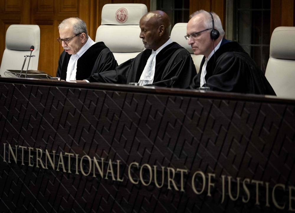 (From L) Judge Nawaf Salam, Judge Abdulqawi Ahmed Yusuf and Judge Georg Nolte attend a hearing at the International Court of Justice (ICJ) as part of South Africa's request on a Gaza ceasefire in The Hague. AFP