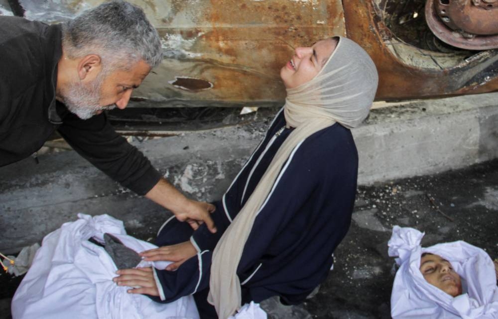 Mourners react next to the bodies of Palestinians killed in an Israeli strike in Gaza City, on Saturday. REUTERS