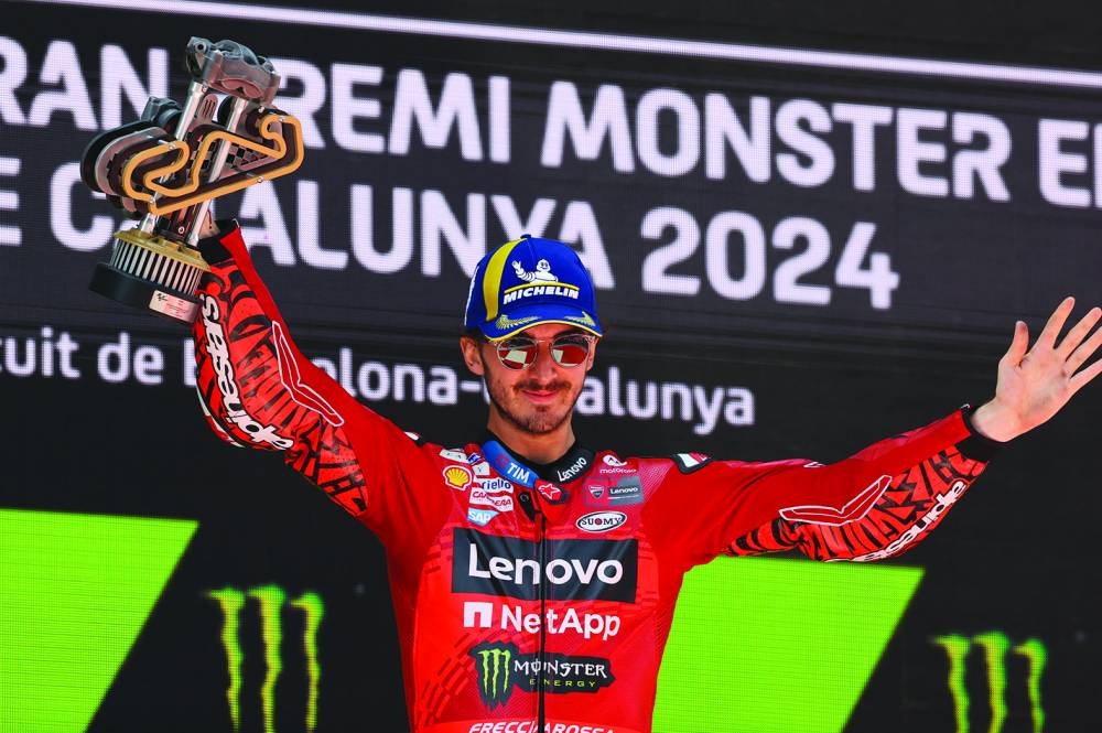 Ducati Lenovo Team’s Francesco Bagnaia celebrates with the winner’s trophy on the podium after clinching the Catalunya Grand Prix at Circuit de Barcelona-Catalunya, Spain, on Sunday. (Reuters)