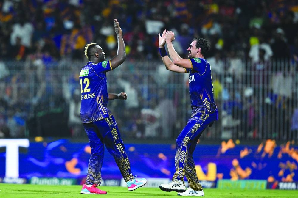 Kolkata Knight Riders’ Andre Russell (left) celebrates with his teammate Mitchell Starc after taking the wicket of Sunrisers Hyderabad’s Aiden Markram during the Indian Premier League final on Sunday. (AFP)
