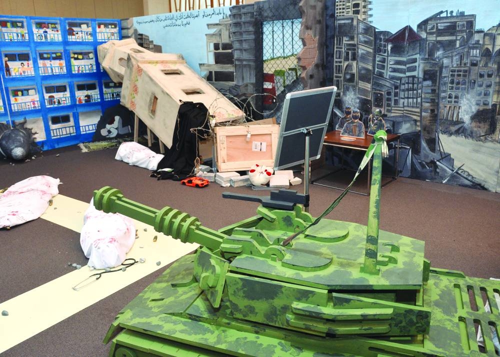 A model of a bombed minaret that fell on a praying man- in background, model of a UNRWA school that was turned into a shelter. PICTURES: Shaji Kayamkulam