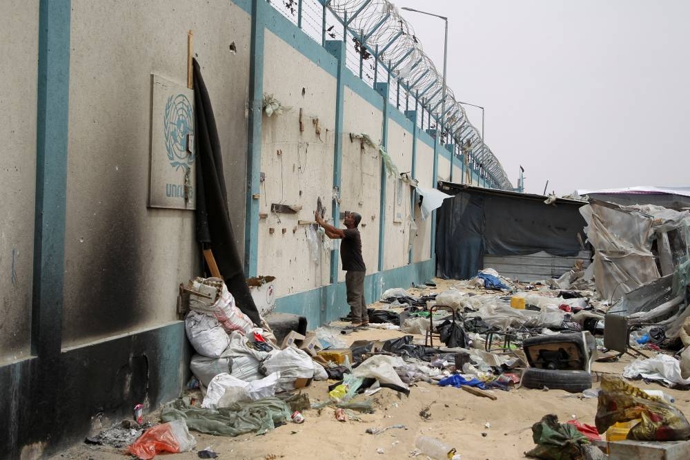 A man stands at a tent camp damaged in an Israeli strike during an Israeli military operation, in Rafah, on Tuesday. REUTERS